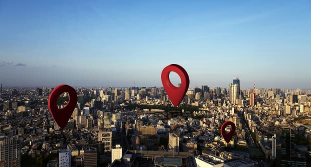 Aerial city skyline view with red location markers indicating regional store network